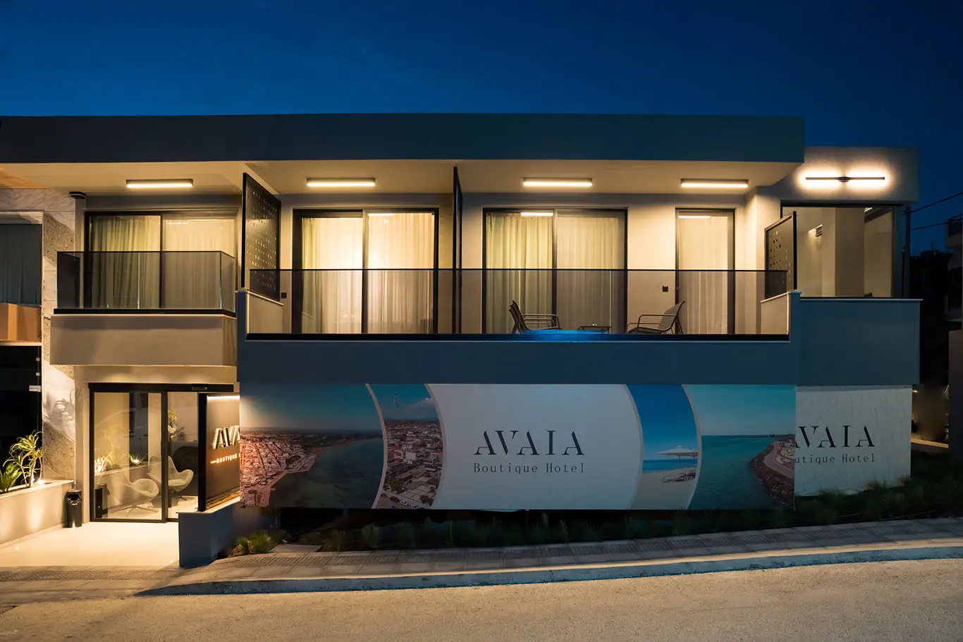 Night view of the illuminated Avaia Boutique Hotel exterior and balconies in Moudania