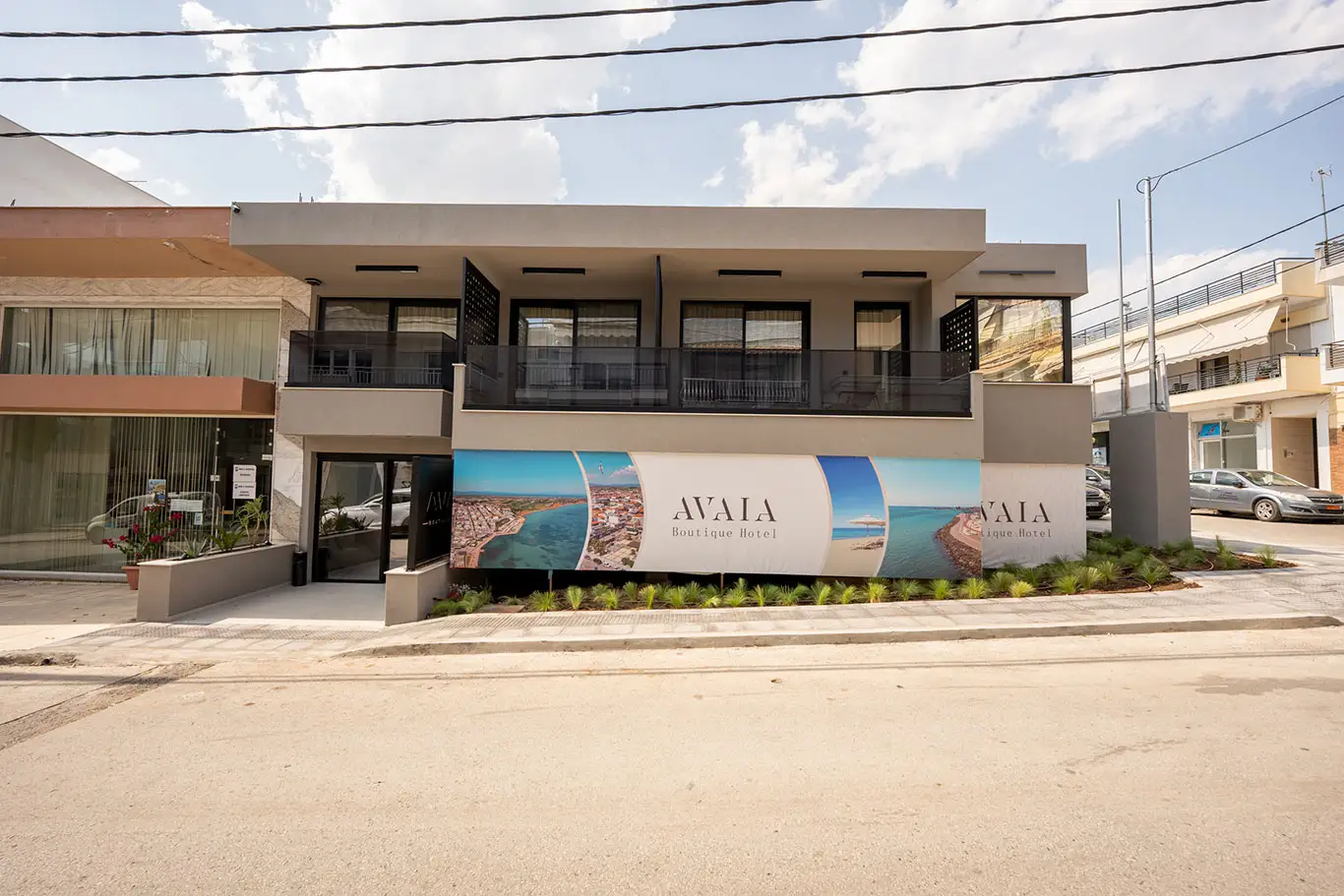 Front daytime view of Avaia Boutique Hotel in Moudania with balconies and hotel signage