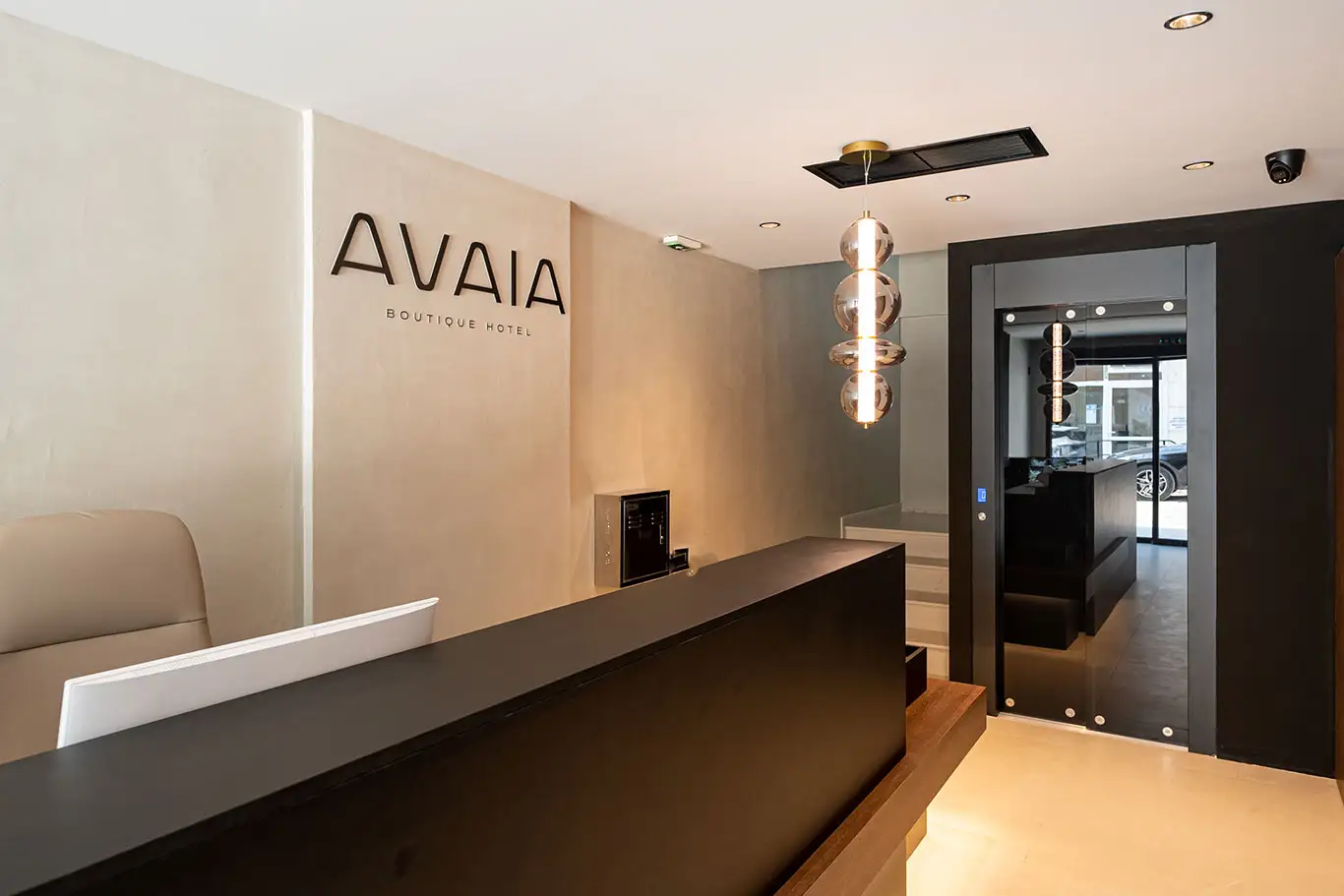 Avaia Boutique Hotel lobby in Moudania with reception desk, wall logo and decorative lighting