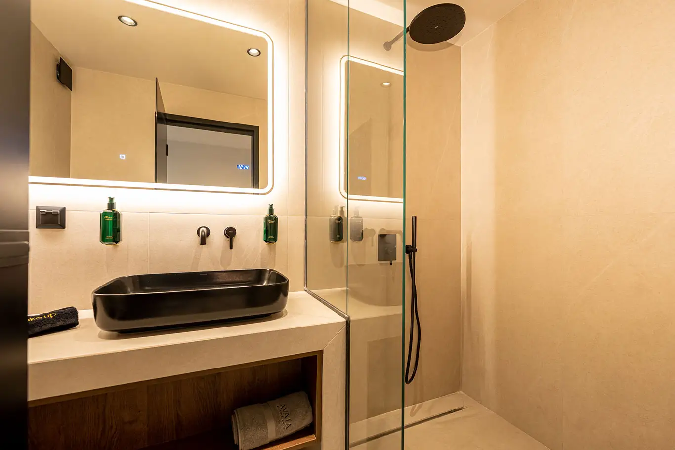 Modern bathroom with black washbasin and glass walk-in rain shower in Classic Luxury Room 101