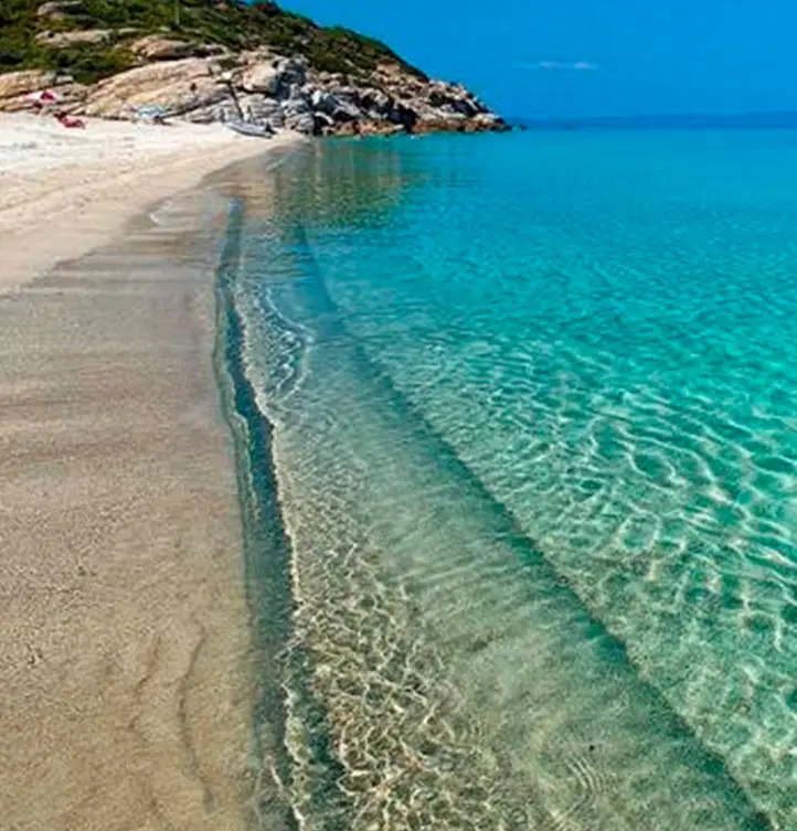 Dionysiou Beach with clear shallow waters and sandy shoreline